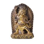 A small Tibetan gilt-bronze shrine, depicting Vajrapani, the dwarf like figure wearing a tiger