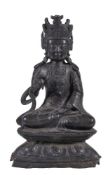 A Chinese bronze Buddha, Ming Dynasty, seated on a double lotus throne, his hands in vitarka and