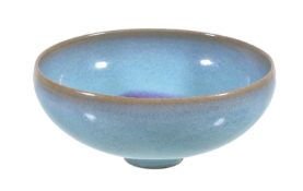 A Chinese 'Jun' type small bowl, well potted and covered in a sky-blue glaze and a crimson splash to