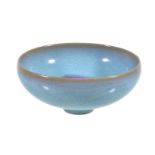 A Chinese 'Jun' type small bowl, well potted and covered in a sky-blue glaze and a crimson splash to