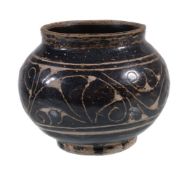 A small Chinese 'Cizhou' sgraffiato 'floral' jar, covered with a dark brown glaze, carved through