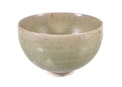 A Chinese celadon stoneware bowl, with deep rounded sides, the raised foot and part of underside