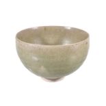 A Chinese celadon stoneware bowl, with deep rounded sides, the raised foot and part of underside