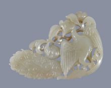 A Chinese pale celadon and russet 'peacock' pendant, with pierced work, 7.3cm high x 5cm wide x