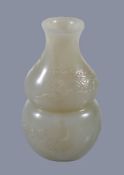 A small Chinese white or pale celadon jade 'bat and cloud' vase, of double-gourd form carved with