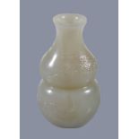 A small Chinese white or pale celadon jade 'bat and cloud' vase, of double-gourd form carved with