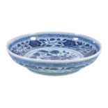 A attractive small Chinese blue and white 'Lotus Bouquet' dish, painted to the interior with a