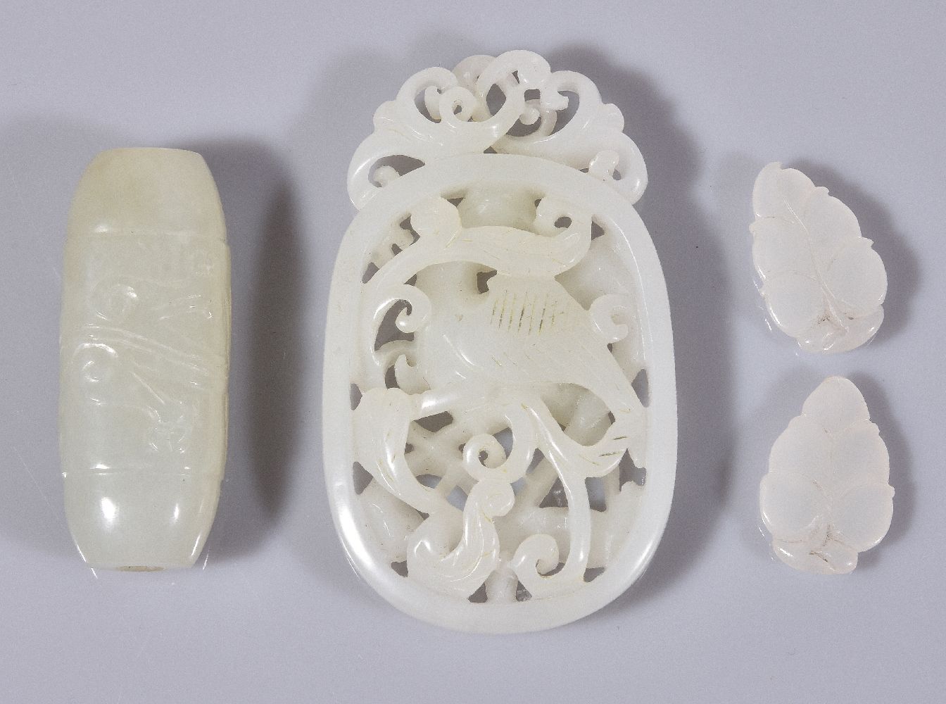 A Chinese white jade openwork pendant, carved with a bird amongst scrolling foliage, incised - Image 2 of 2