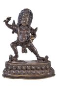 A Tibetan bronze figure of Vajrapani, 19th century, the fierce deity standing on two prostrate