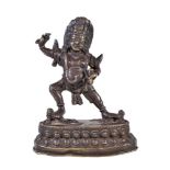 A Tibetan bronze figure of Vajrapani, 19th century, the fierce deity standing on two prostrate