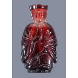 A Chinese Peking glass red snuff bottle and stopper, probably circa 1920, depicting a monk,