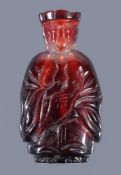 A Chinese Peking glass red snuff bottle and stopper, probably circa 1920, depicting a monk,