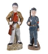 Two Chinese ‘Red Guard’ figures, the faces in biscuit porcelain, 28.5cm and 31cm high (2)