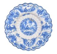 A Dutch Delft blue and white dish in the Transitional style, circa 1700, of fluted form, cracked,