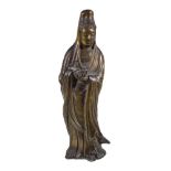 A Chinese gilt-bronze figure of Guanyin, standing holding a scroll, traces of gilding, 26cm high