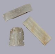 A Chinese Archaistic pale celadon and russet jade scabbard slide, Qing Dynasty or earlier, of