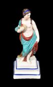 A Neale & Co. creamware figure of a classical maiden modelled holding an apple, circa 1780, on a