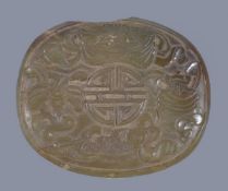 A Chinese celadon jade oval plaque, probably 19th century, 8.5cm wide x 7.2cm high