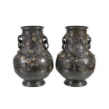 A pair of Chinese bronze and champleve vases, applied in relief with fruiting gourd vines and