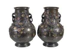 A pair of Chinese bronze and champleve vases, applied in relief with fruiting gourd vines and