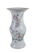 A Chinese Famille Rose vase, circa 1900, of slender baluster form with trumpet neck, painted with