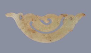 A small celadon jade Archaistic pendant, in Warring States style, well carved, 8.4cm long x 3cm high