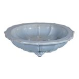 A Chinese lavender glazed dish, with barbed rim and supported on three feet, the base with