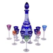 A Czechoslovakian clear cut glass and blue flashed spirit set, comprising a slender decanter and