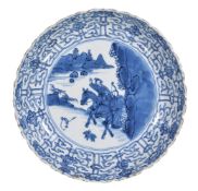 A Chinese blue and white plate, Kangxi, painted with a huntsman on horseback with attendant,