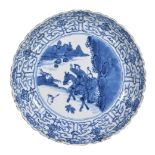 A Chinese blue and white plate, Kangxi, painted with a huntsman on horseback with attendant,