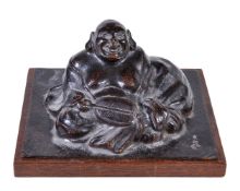 A Japanese copper figure of Hotei, the corpulent figure holding an uchiwa in one hand and