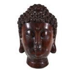 A Chinese wood Buddha head, possibly aloeswood, the head with carved tight curls, 25.5cm high, 1,482