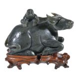 A Chinese green jadeite 'Buffalo and Child' carving, the recumbent animal with the young boy