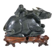 A Chinese green jadeite 'Buffalo and Child' carving, the recumbent animal with the young boy