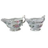 A pair of Worcester moulded polychrome sauce boats, circa 1770, painted with flowers, paper labels