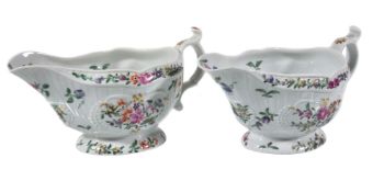 A pair of Worcester moulded polychrome sauce boats, circa 1770, painted with flowers, paper labels