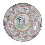 A Japanese porcelain circular charger, circa 1900-1920, painted in pink, green, turquoise and yellow