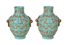 A pair of Chinese turquoise-ground porcelain vases, with moulded animals and birds highlighted in