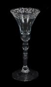 A Newcastle light baluster wine glass, mid 18th century, the bell bowl engraved with stylized