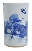 A Chinese blue and white brush vase, painted with a mythical lion and plantain trees, 20cm high