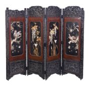 Y A Japanese Four-Fold Wood Screen, the frame carved with reserves of peonies on a diaper ground,