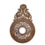 A Chinese Han-style reticulated brown and yellow jade disc, bi, cut with a central openwork of