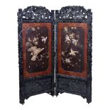Y A Japanese Wood and lacquer Two-Fold Screen, the richly carved black wood frame decorated with