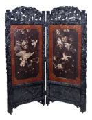 Y A Japanese Wood and lacquer Two-Fold Screen, the richly carved black wood frame decorated with