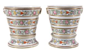 A pair of Paris porcelain jardinières and bases, second quarter 19th century, painted with bands