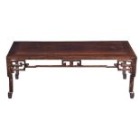A Chinese hardwood low table, late Qing Dynasty, carved with pierced frieze on all sides, four