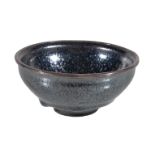 A Chinese Jian type 'oil-spot' tea bowl, heavily potted, the rounded sides rising from a short