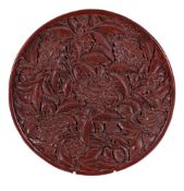 A large Chinese red lacquer tray, in Ming style, of shallow circular form, the interior deeply