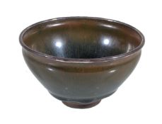 A Jian type 'Hare's Fur' tea bowl, potted with deep sloping walls rising from a short foot ring,