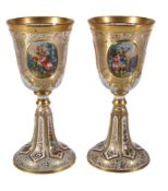 A pair of Bohemian clear glass, gilt and white overlay goblets, third quarter 19th century, the